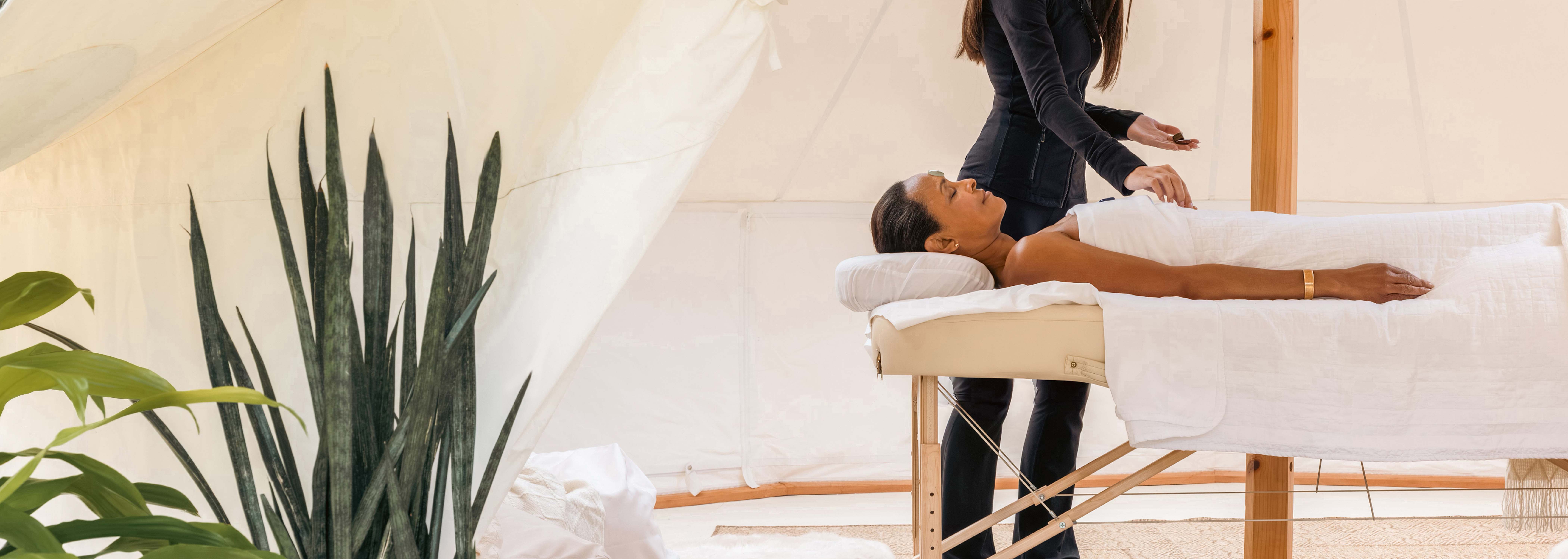 A woman getting a spa service in a tent