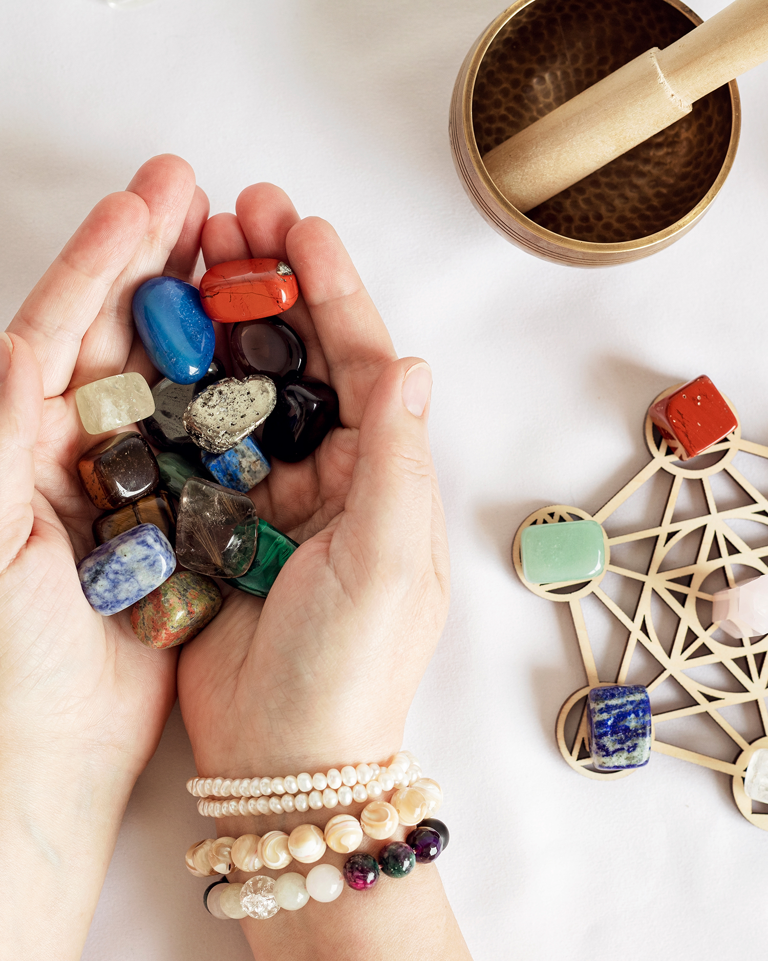 A woman holding chakra stones