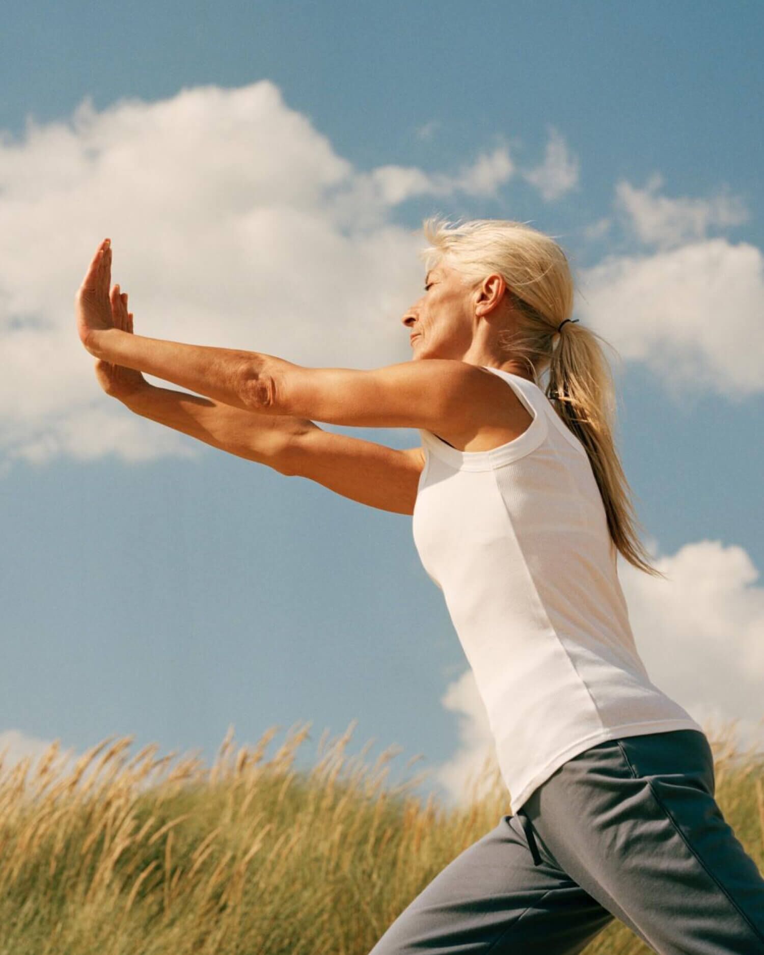 A woman doing Tai Chi outdoors
