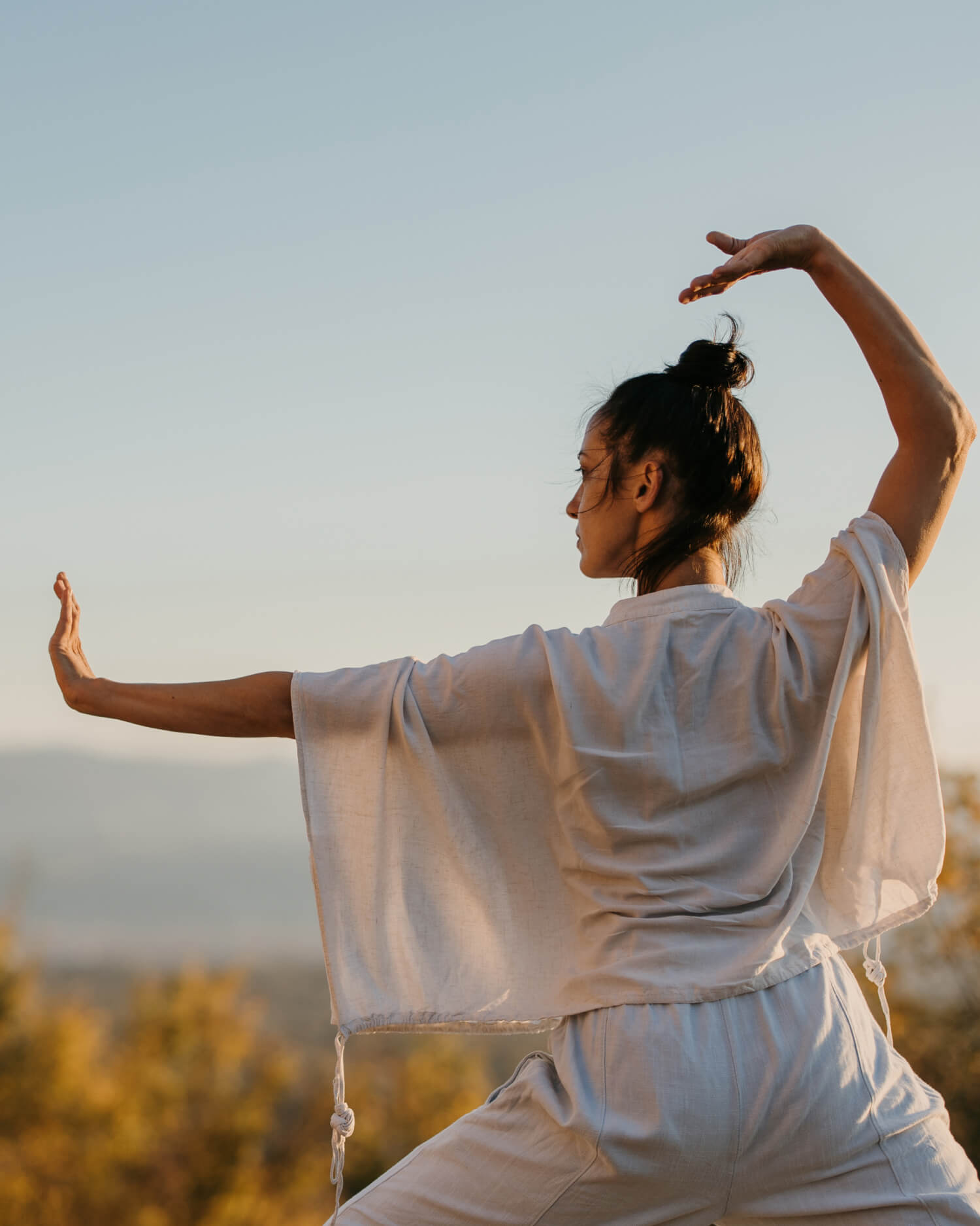 A woman doing Qi Gong outdoors