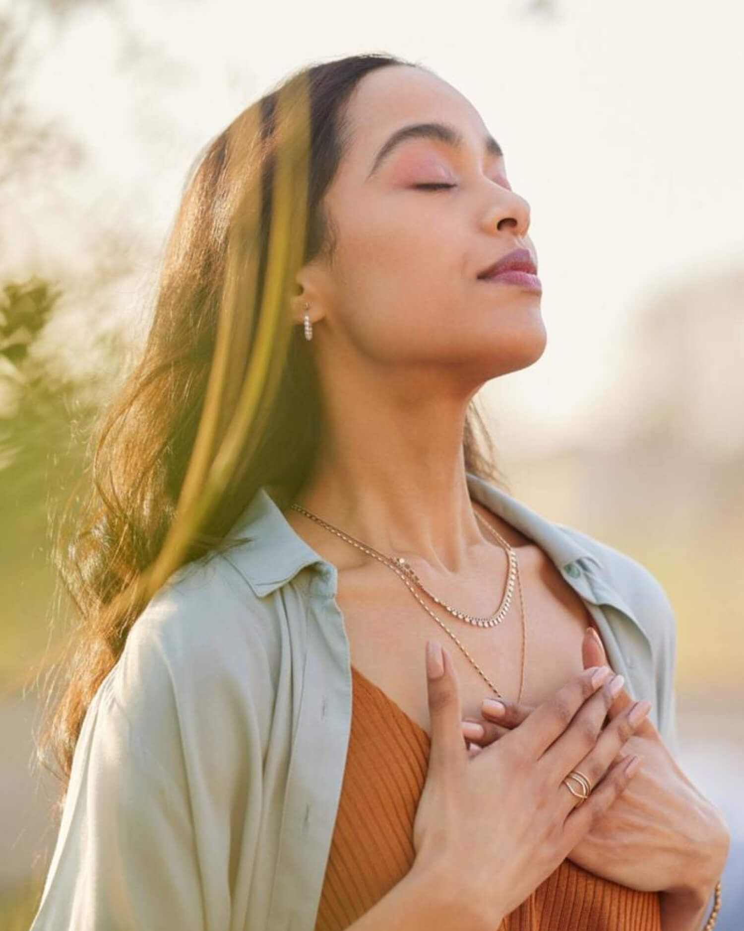 A woman meditating in the sunshine