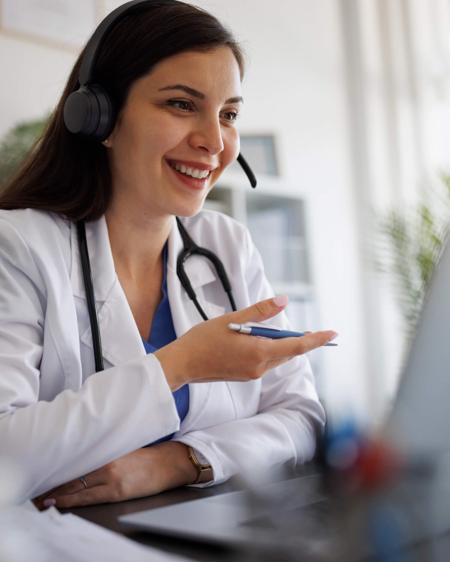 A doctor talking on a computer