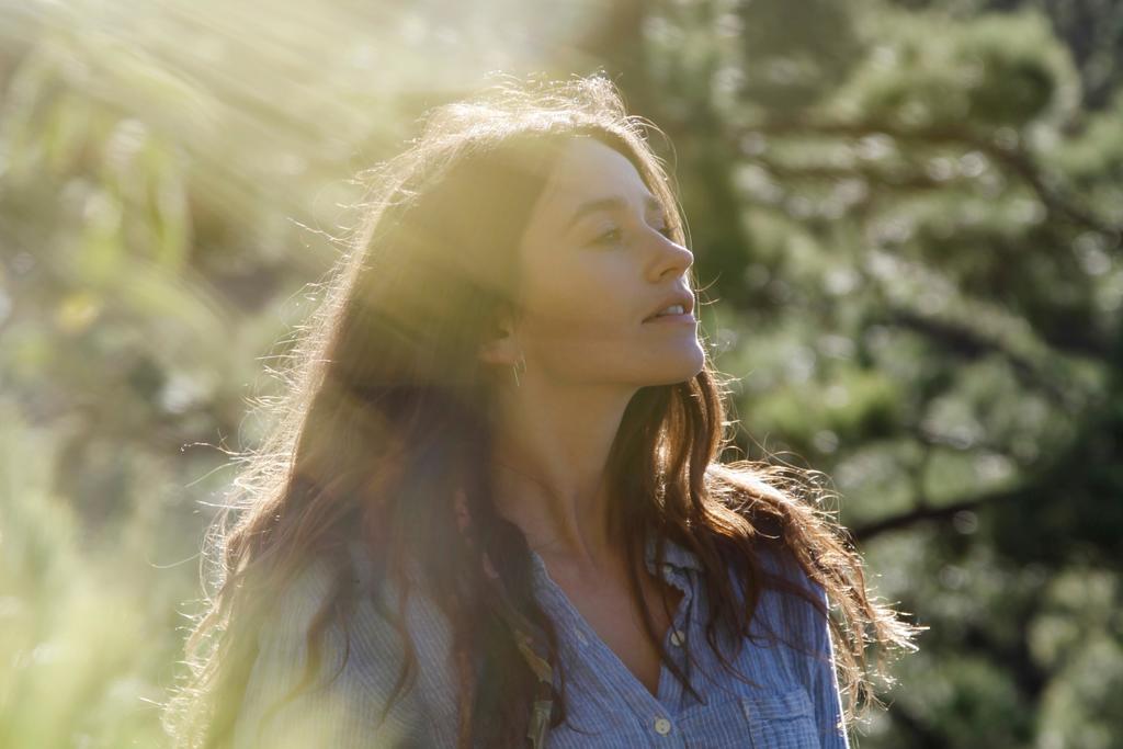 A woman sitting outdoors in the sunshine