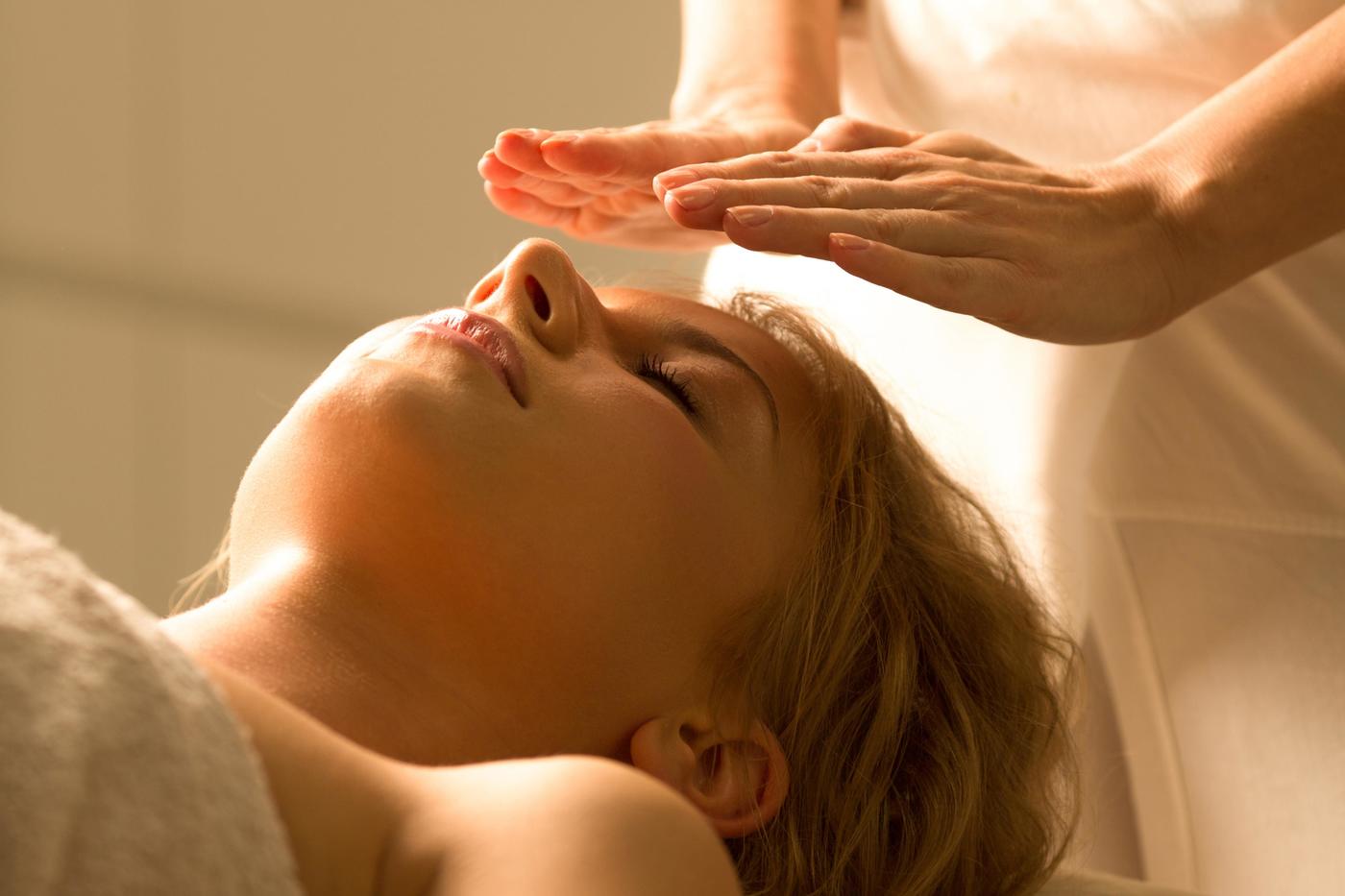 A woman getting a reiki treatment