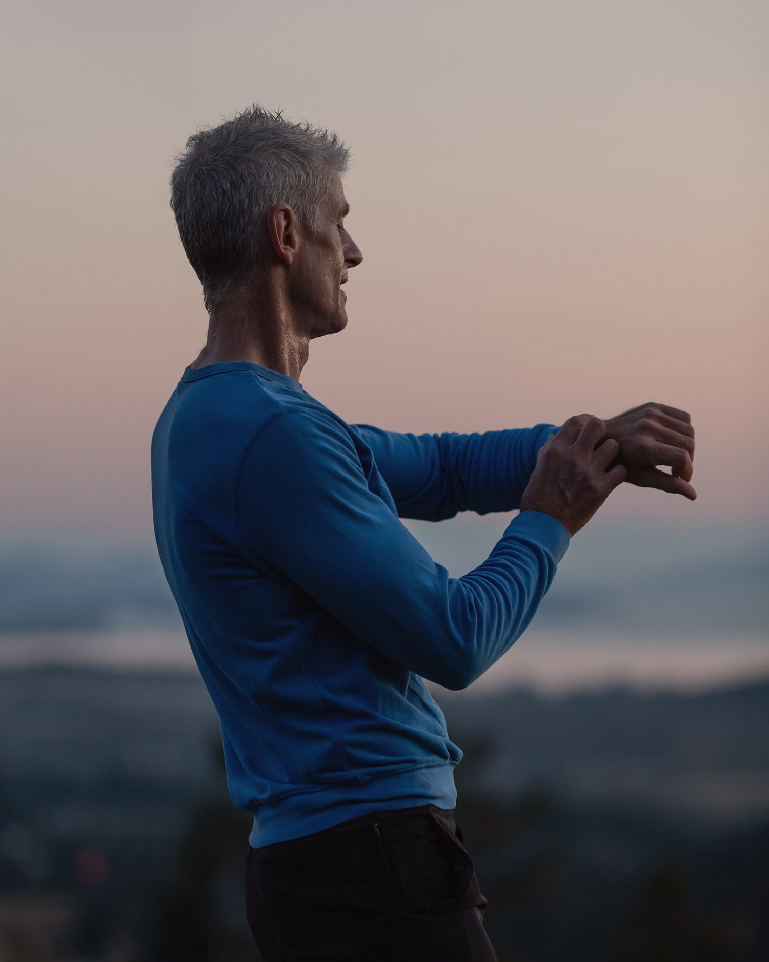 A man on a mountain top working out
