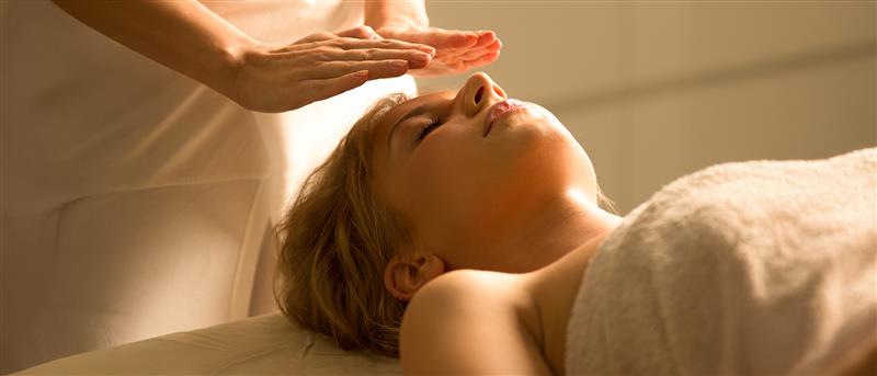 A woman getting a reiki healing