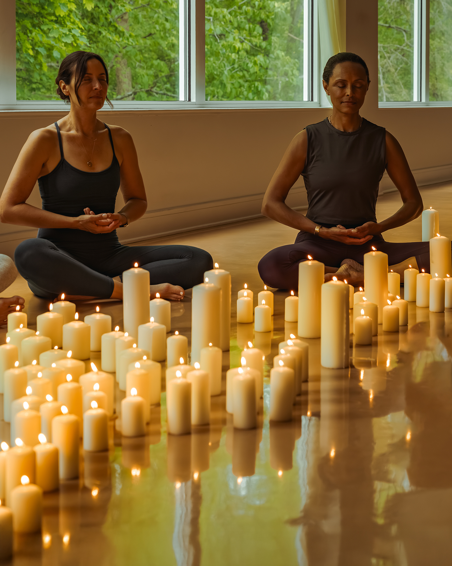 a group meditating in front of candels