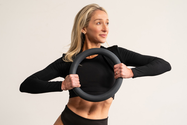 A woman with a pilates ring