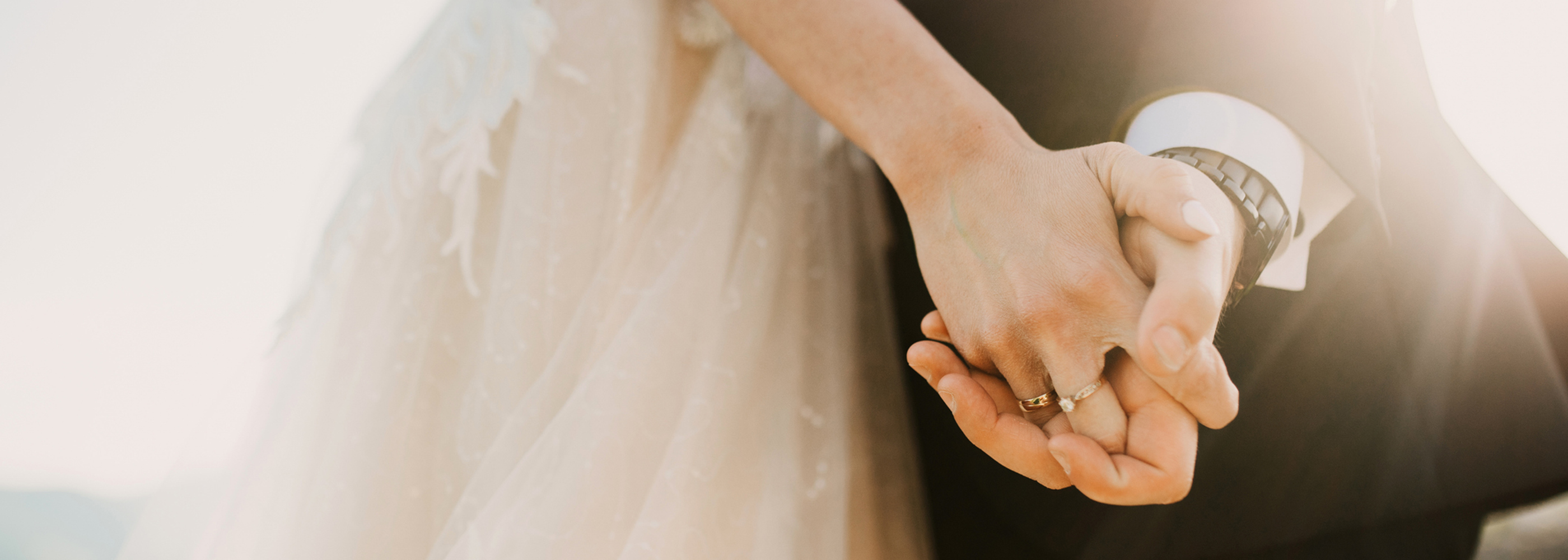 A bride and groom holding hands