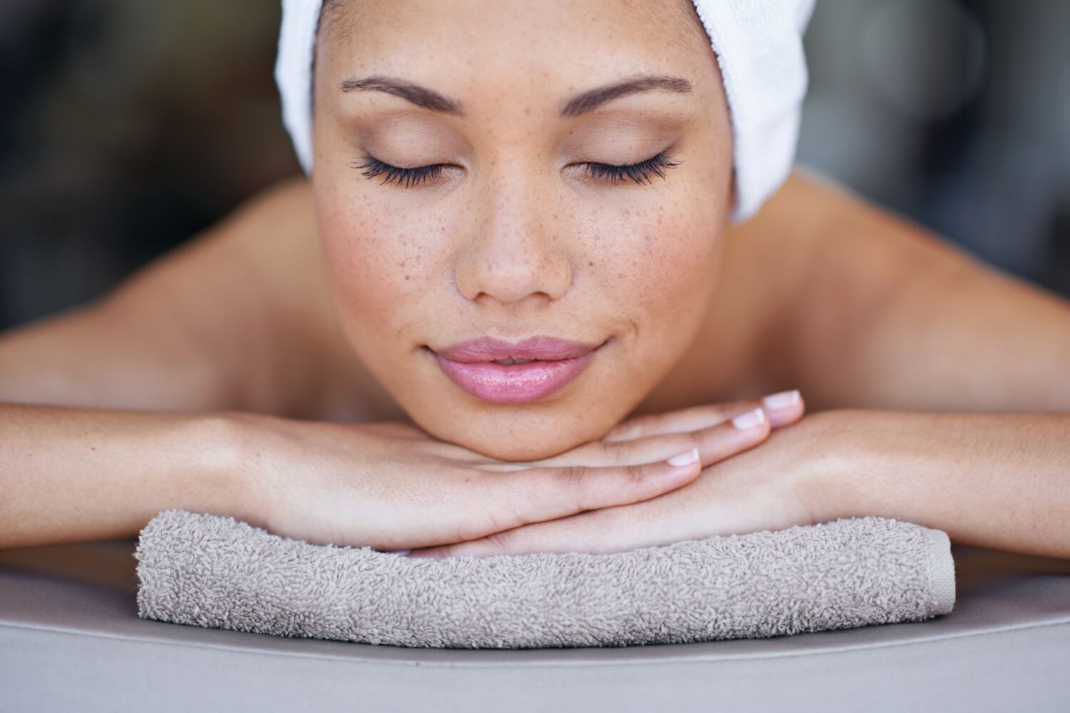 A woman laying in a towl in a spa