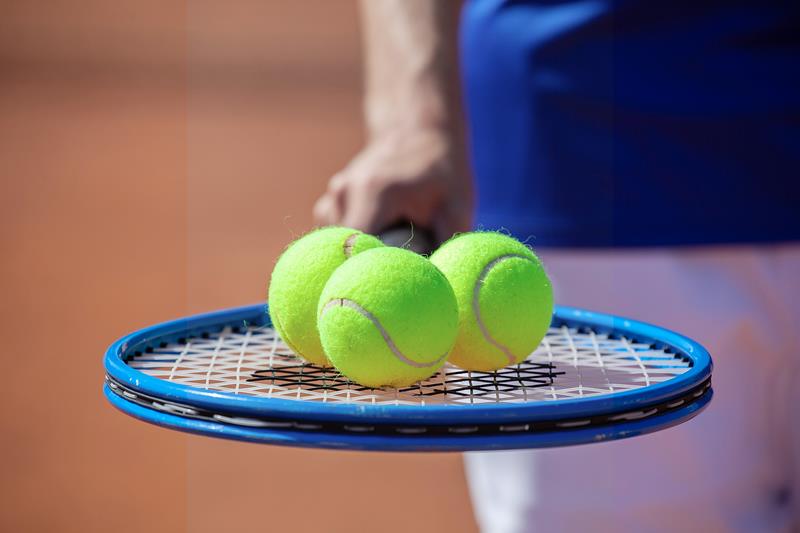 a tennis racquet and tennis balls