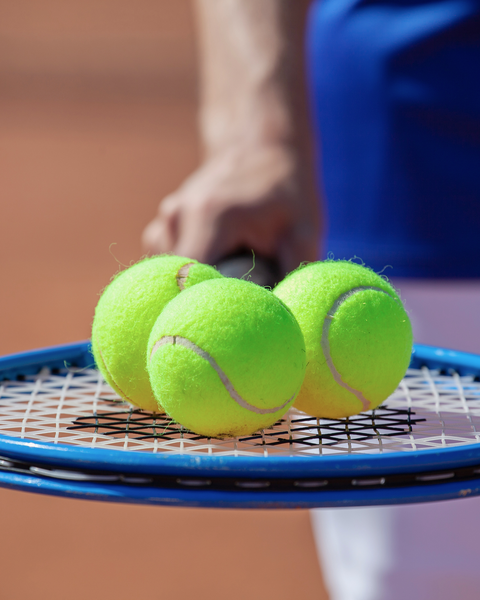 a tennis racquet and tennis balls