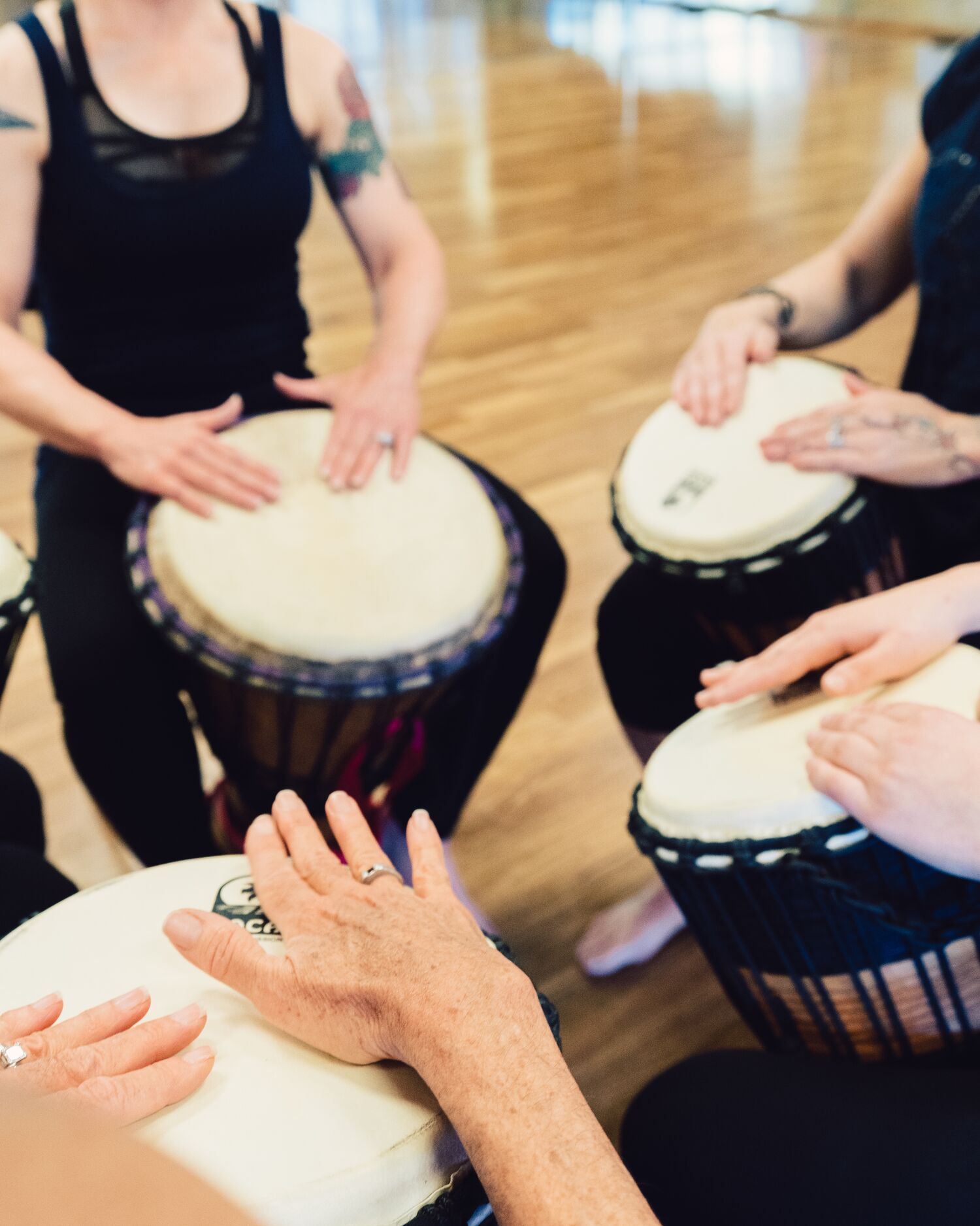 Men & Women Participating in Drumming Circle 