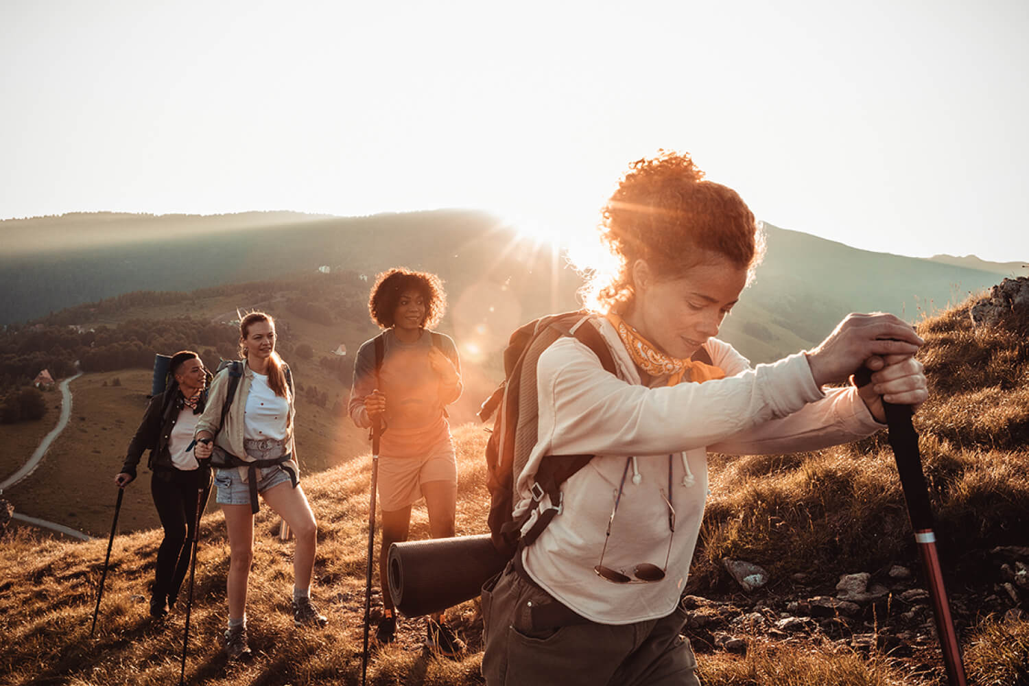 Group Hiking a Mountain During Sunrise