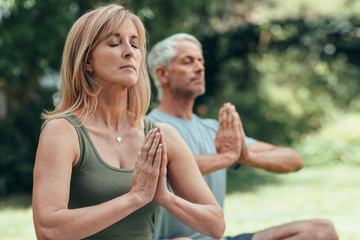 Man and Woman Meditating Outside