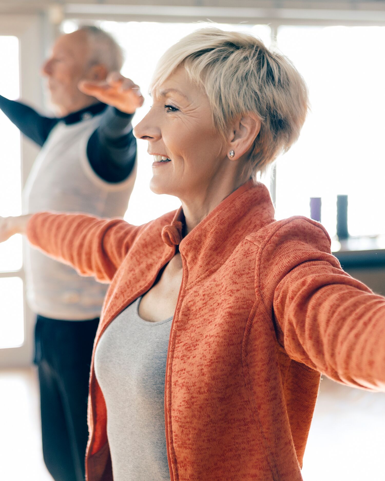 Close-up of Man and Woman Stretching Their Arms Out