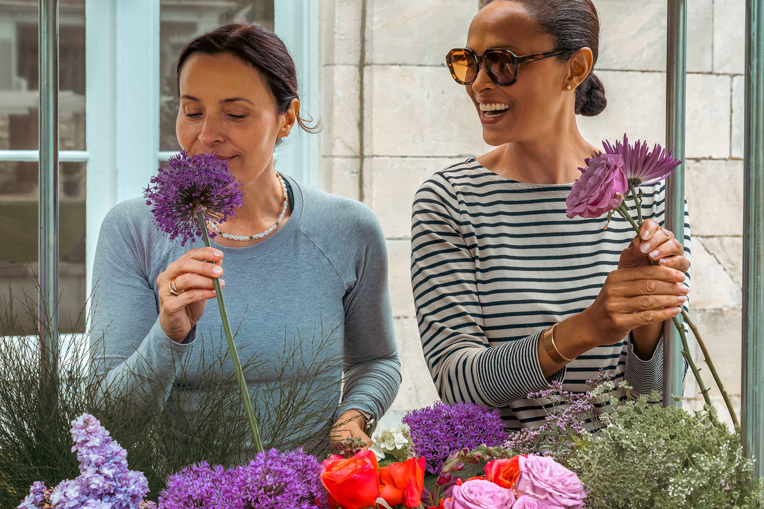 two women picking flowers