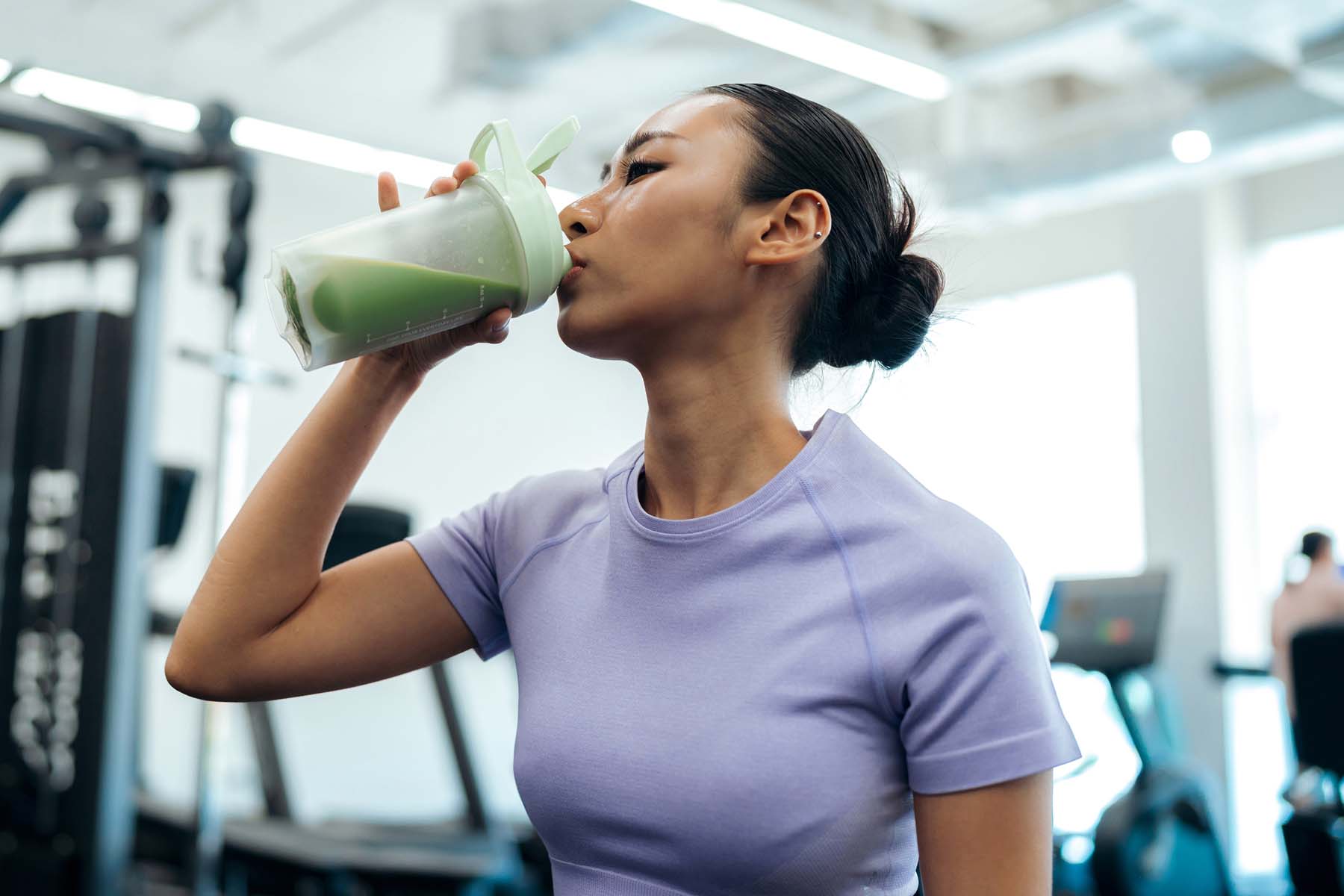 a woman drinking a smoothie