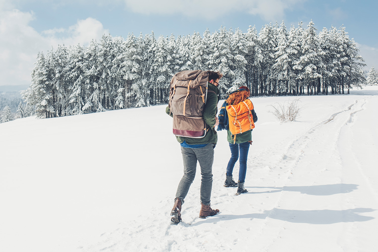 a couple hiking through the snow
