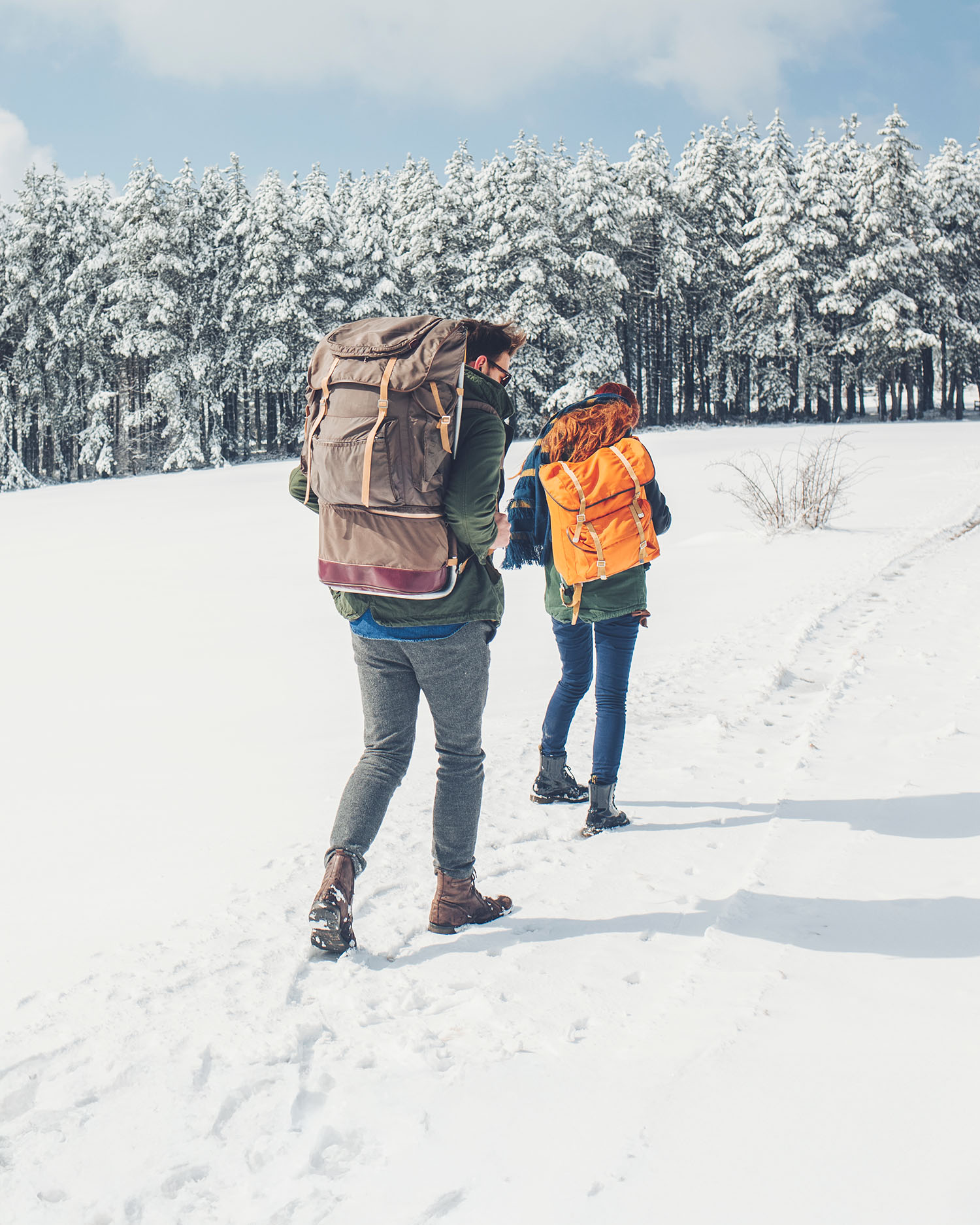 a couple hiking through the snow