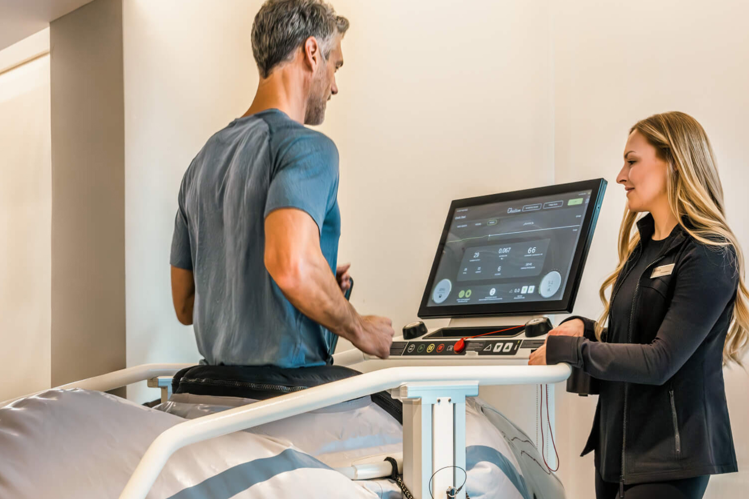 A man on a treadmill with a performance scientist