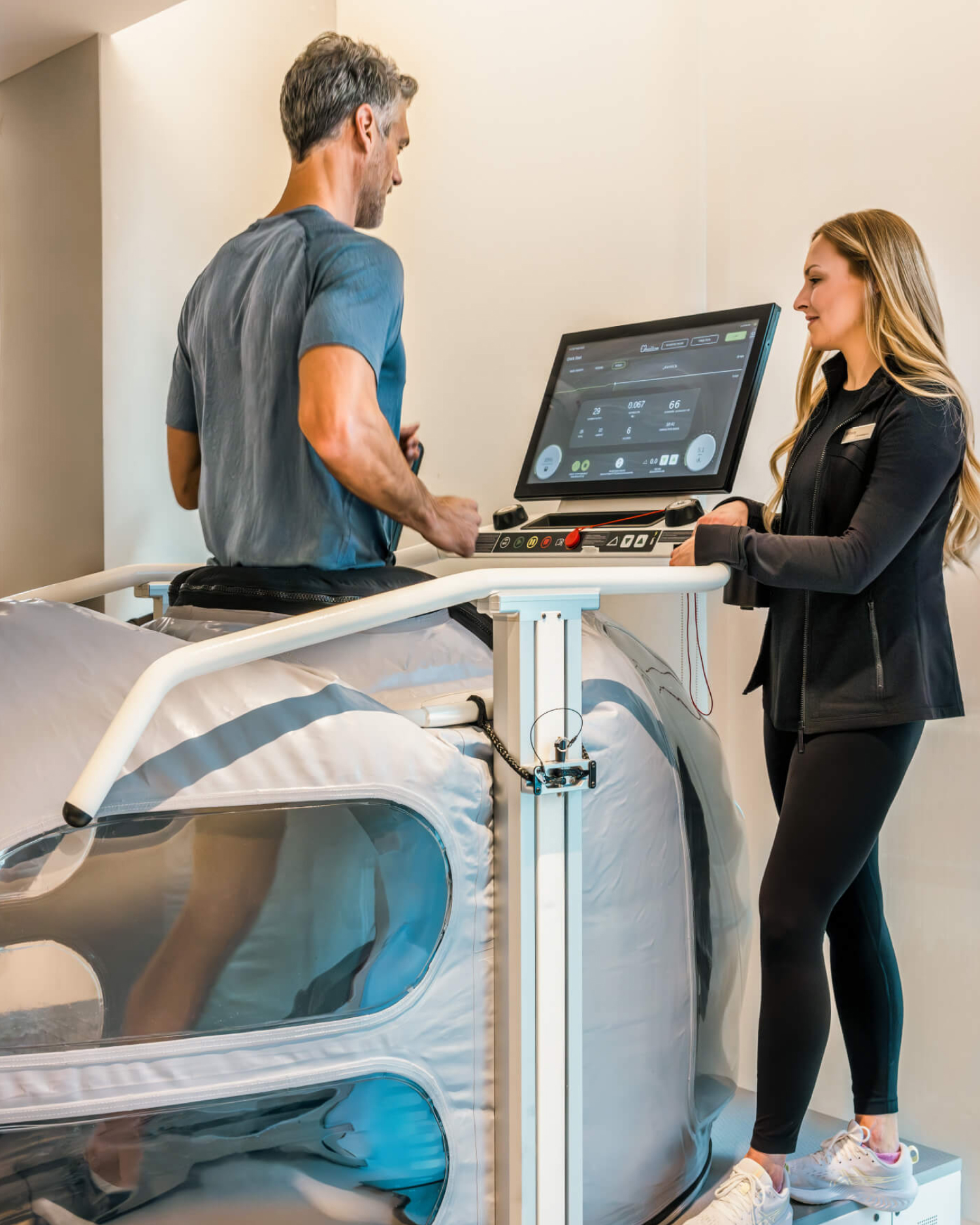 A man on a treadmill with a performance scientist