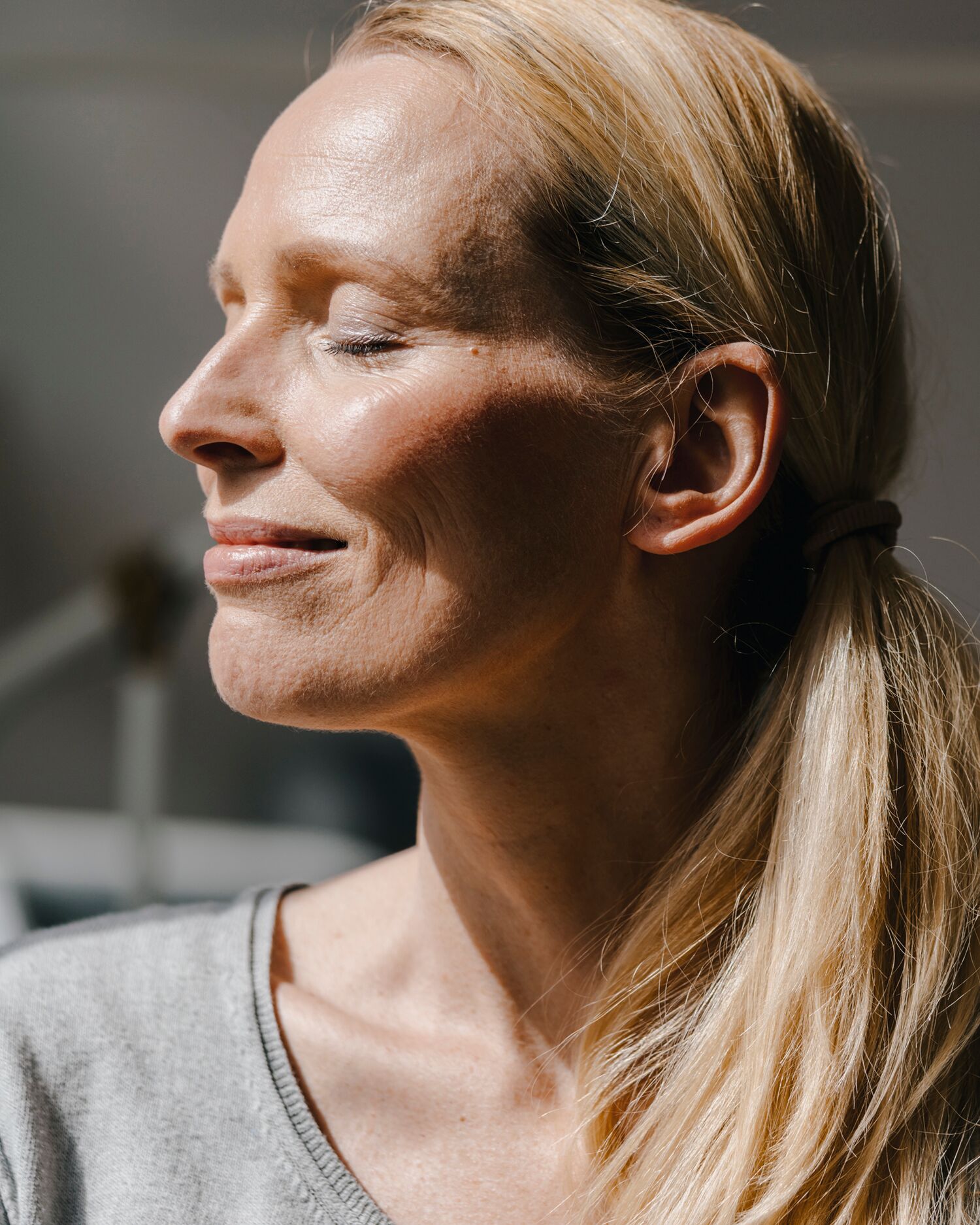 Woman Meditating Contently with Sun in Her Face 