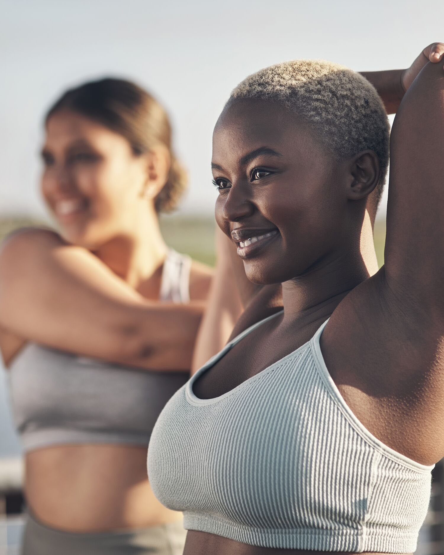 Two Women Exercising and Stretching Outdoors