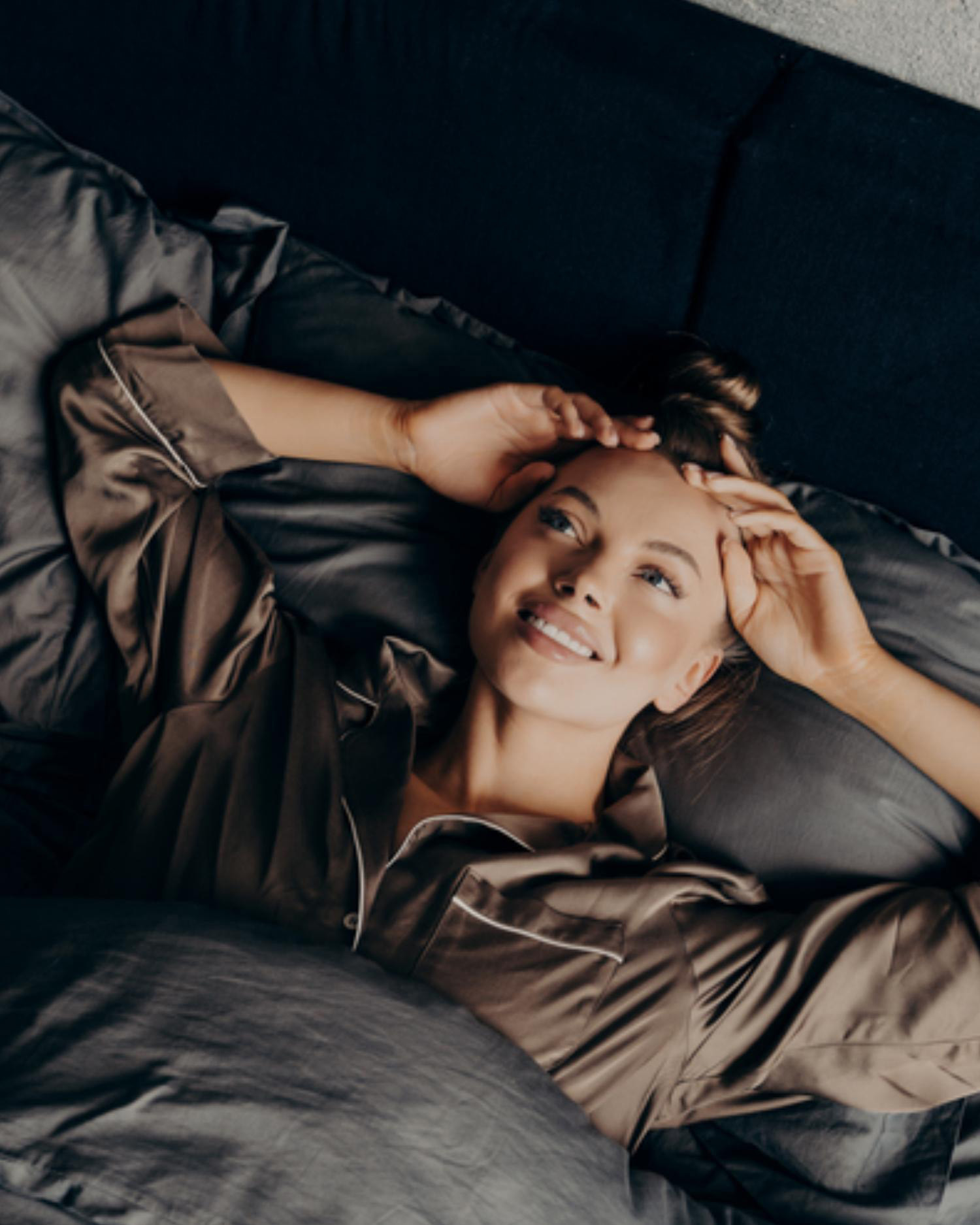 A woman in bed after restorative sleep