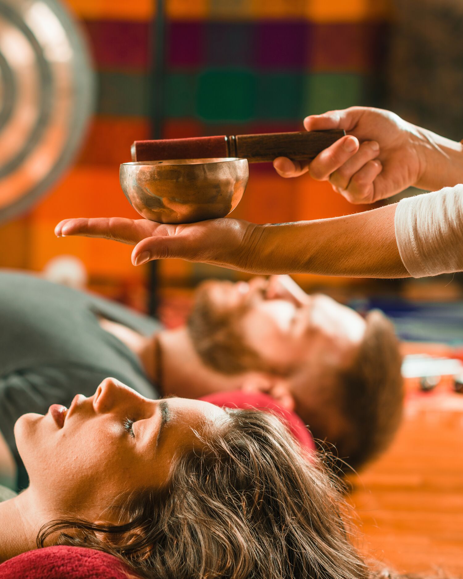 A man and woman getting a sound bath