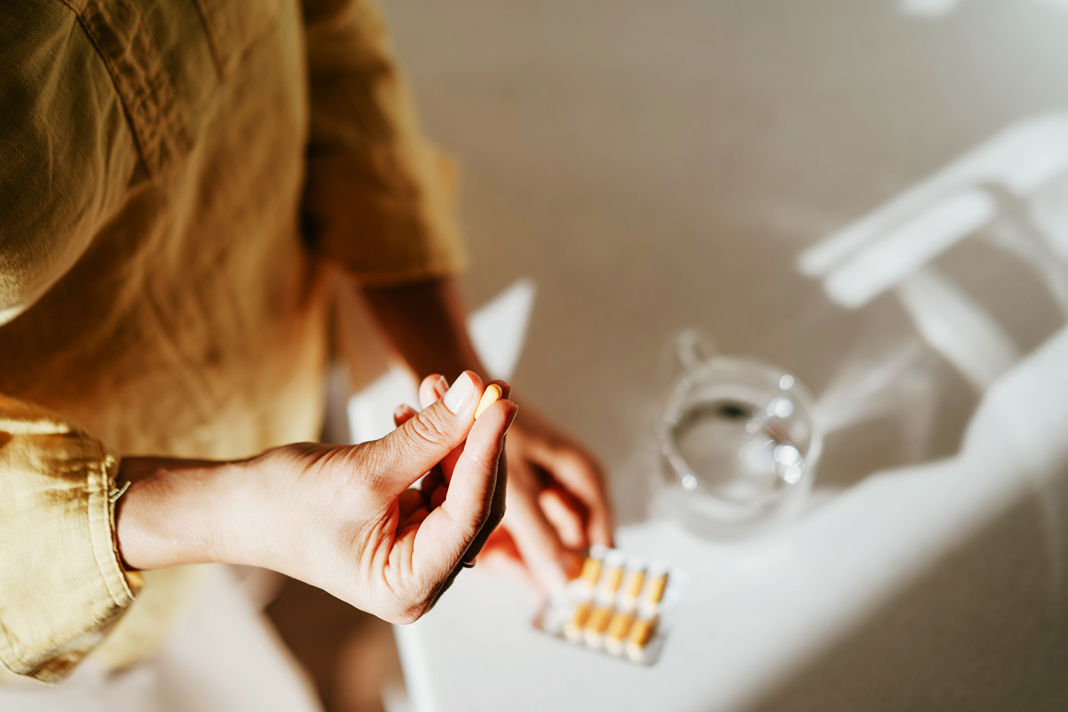 a woman unwrapping a pill
