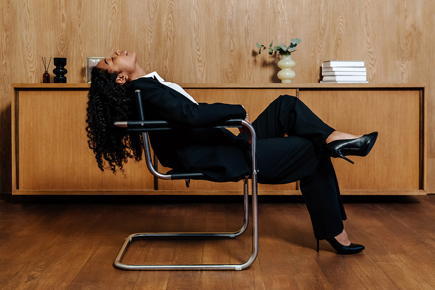 a woman sleeping in an office chair