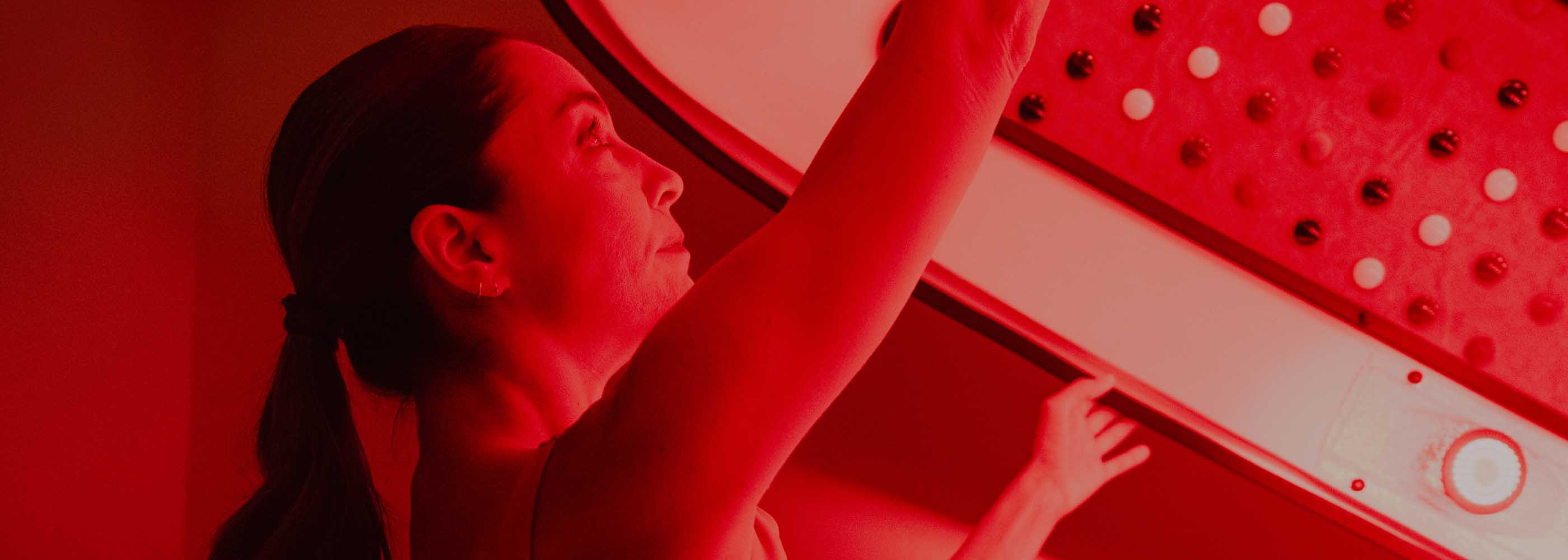 A women in an infrared sauna pod