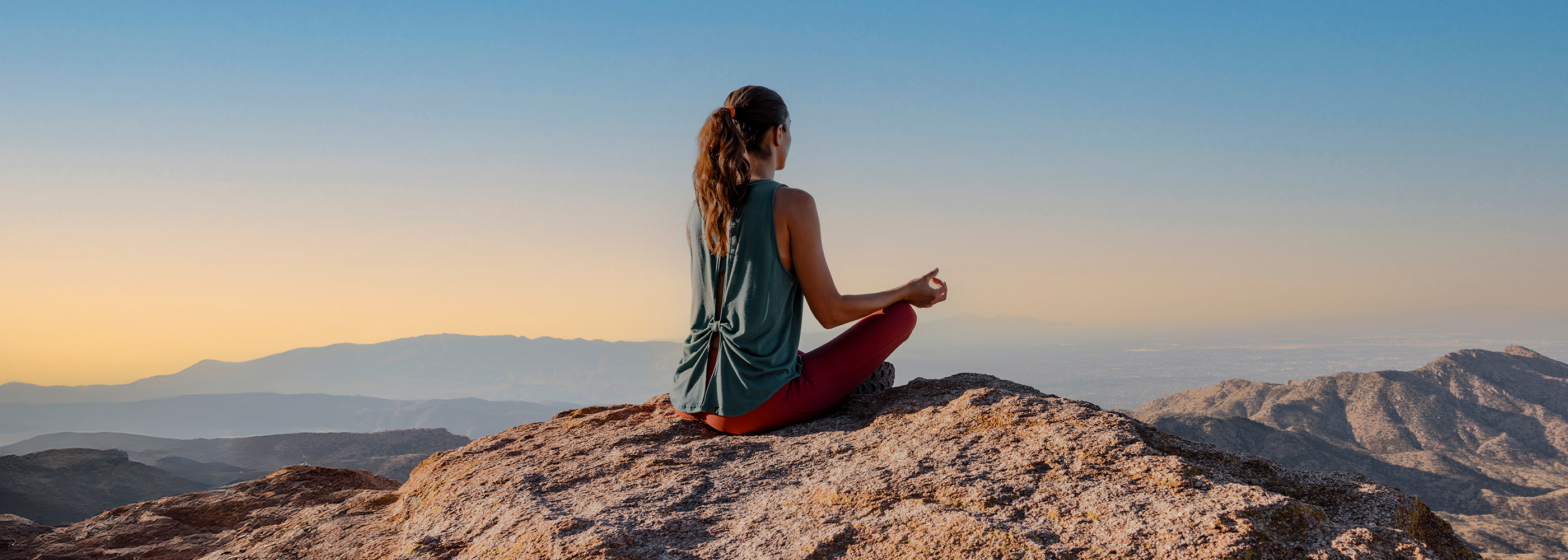 Woman Meditating on Top Mountain in Tucson 