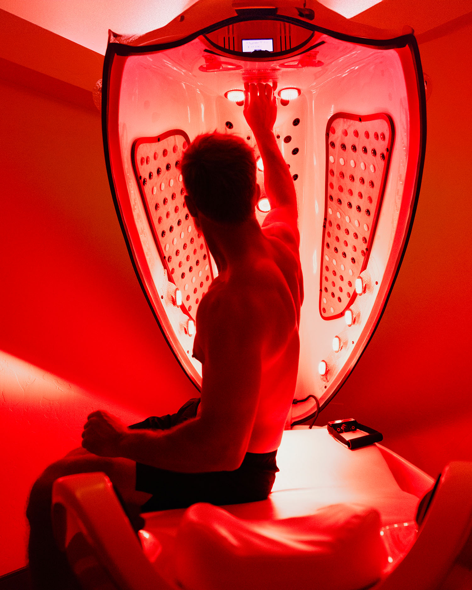 a man in a red light bed