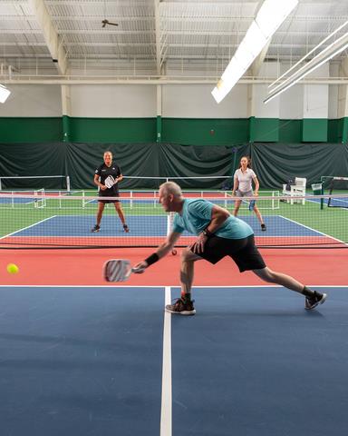 a woman playing pickleball