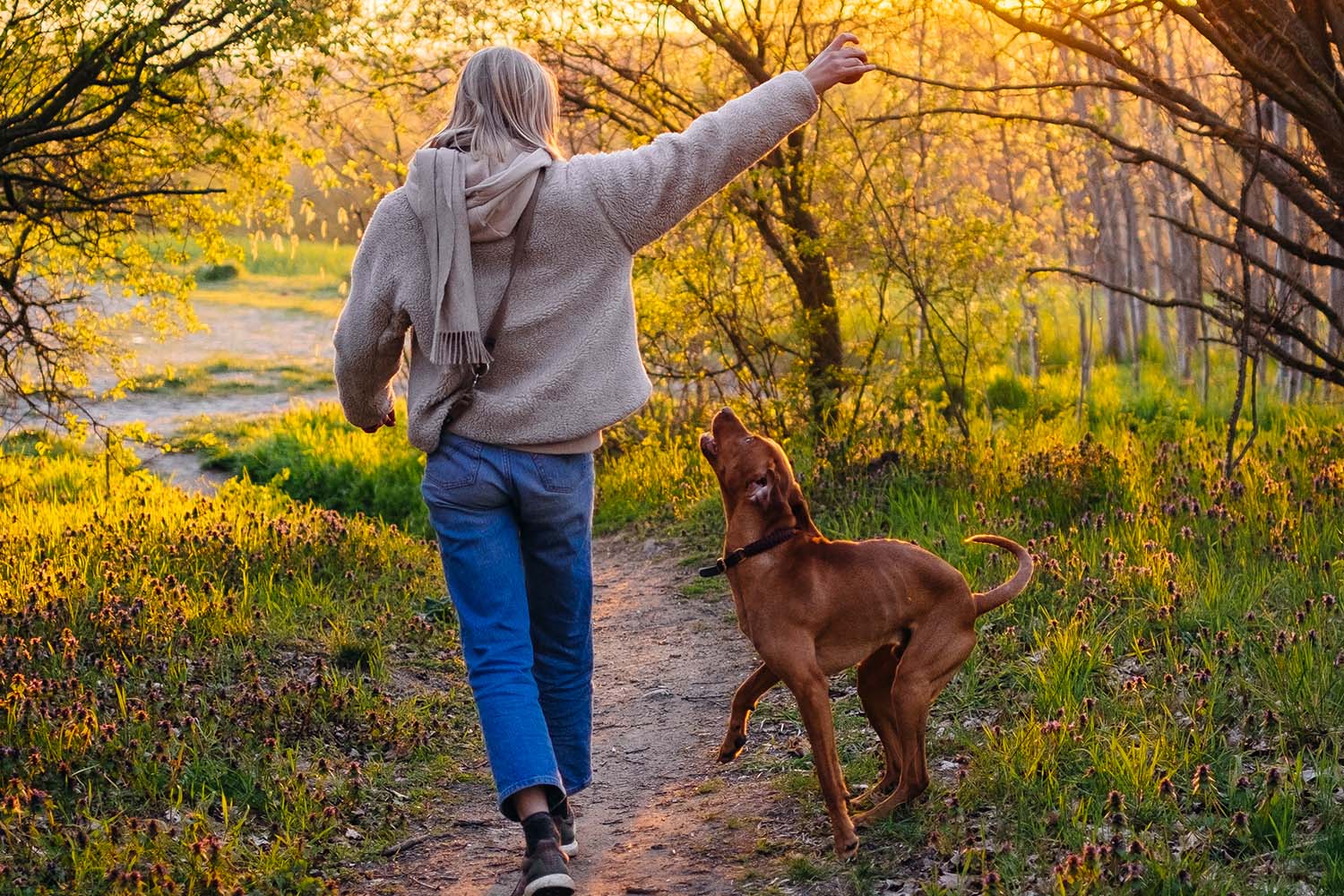 a woman walking with her dog