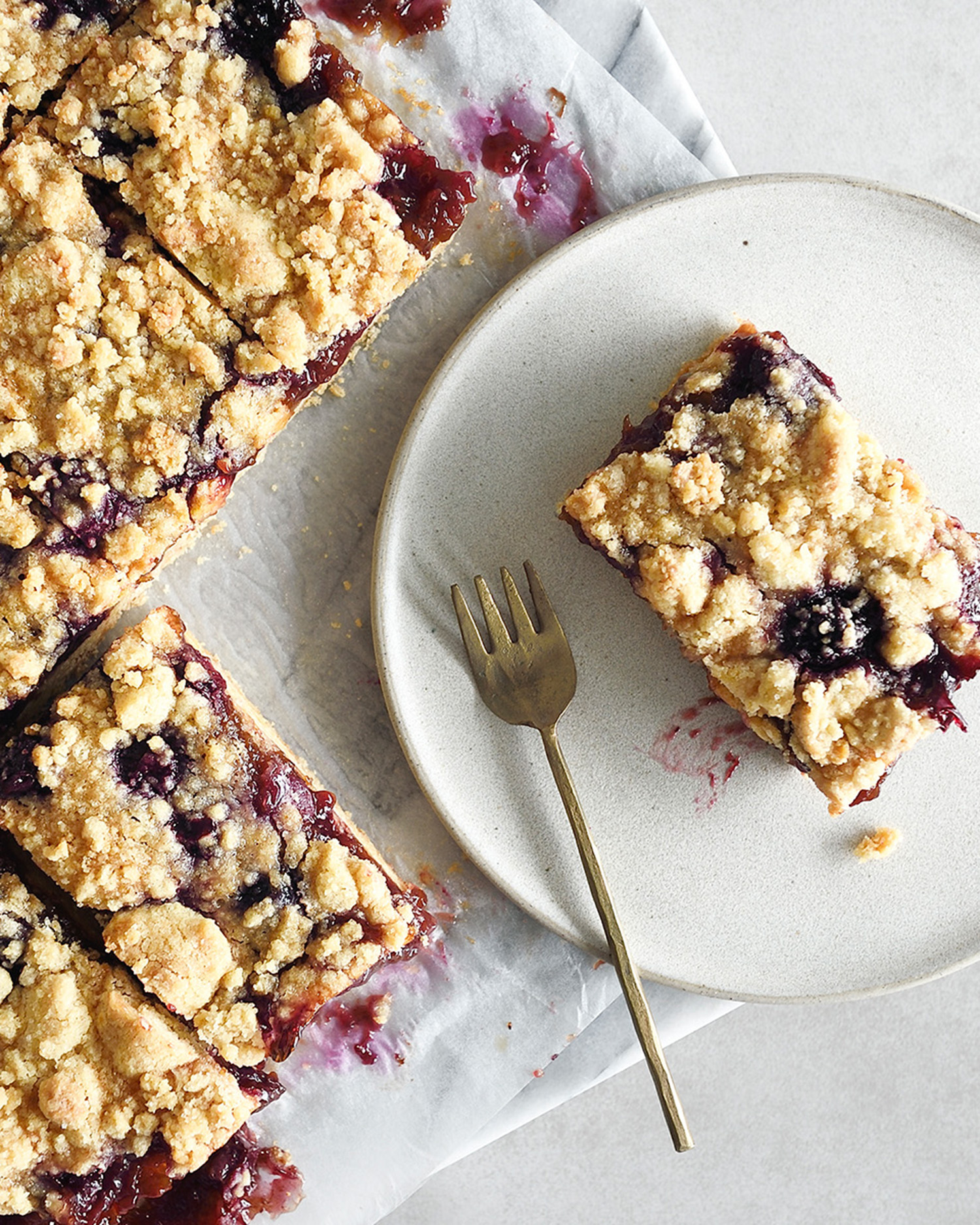 a baking sheet and plate of blueberry oat bars