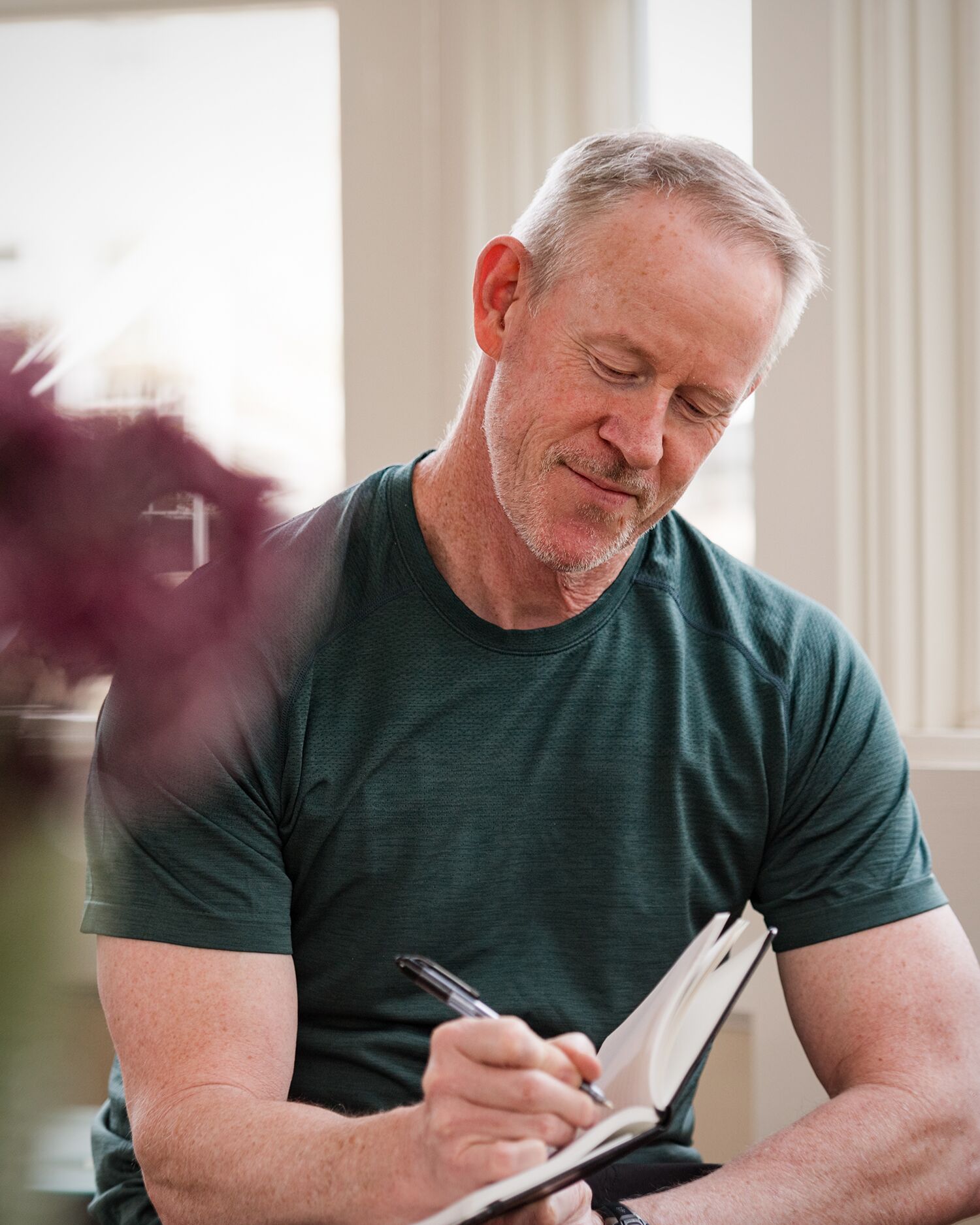 a man writing in a journal