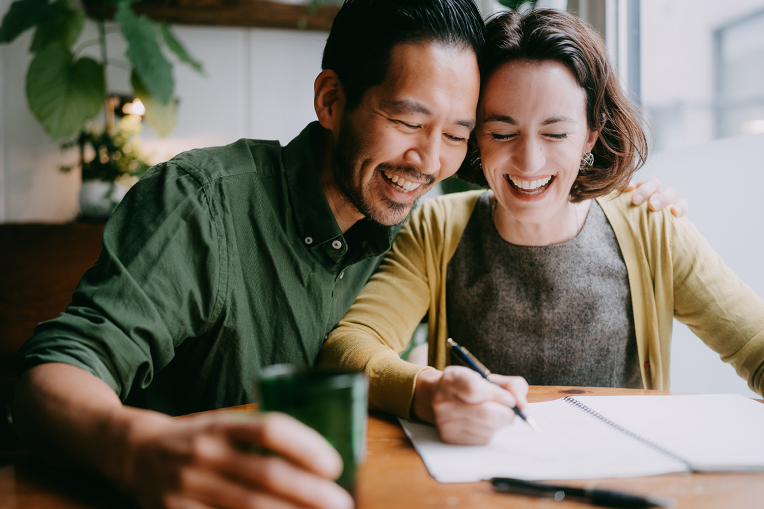 a couple doing finances happily