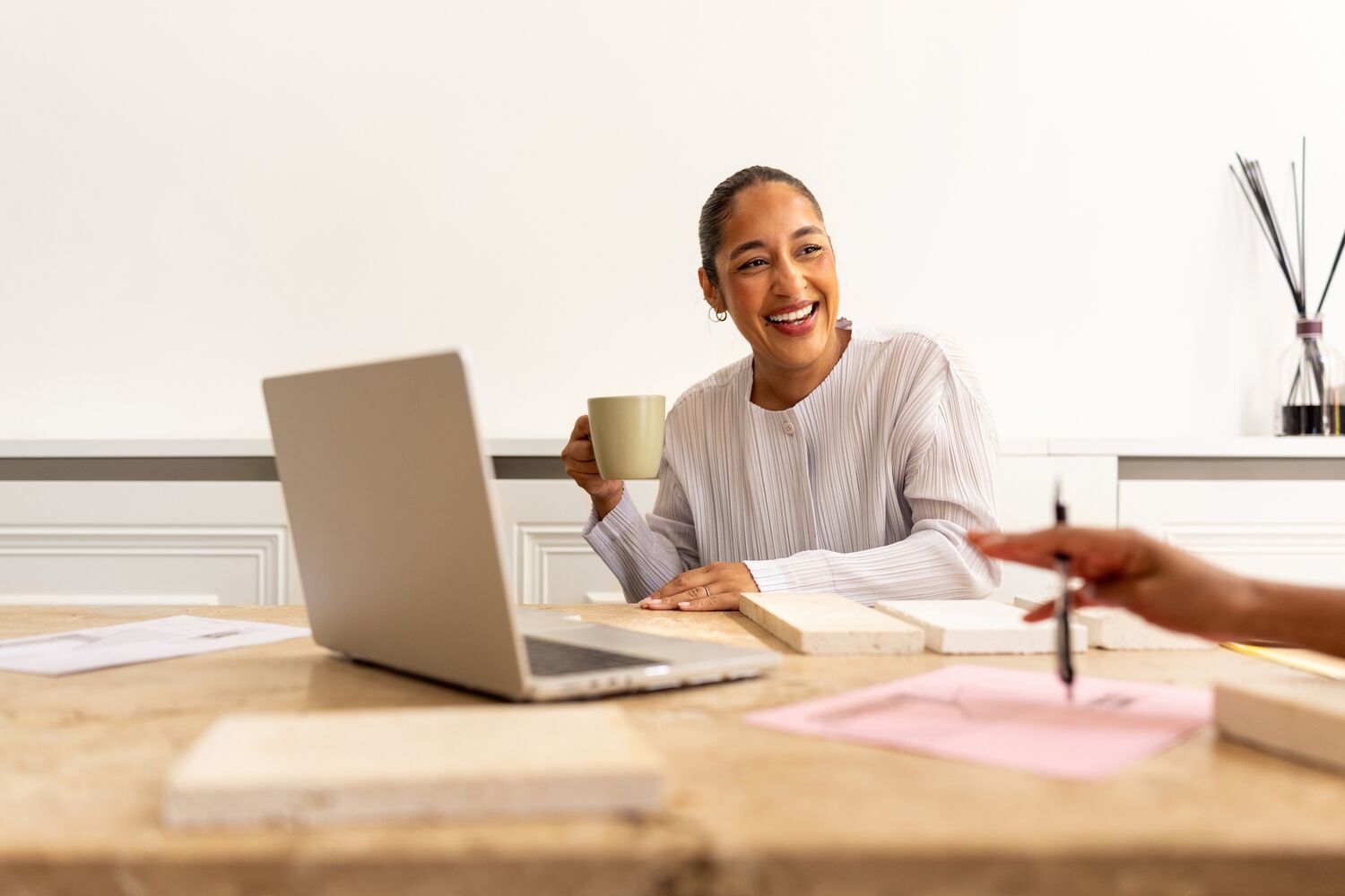 A woman holding a cup of coffee