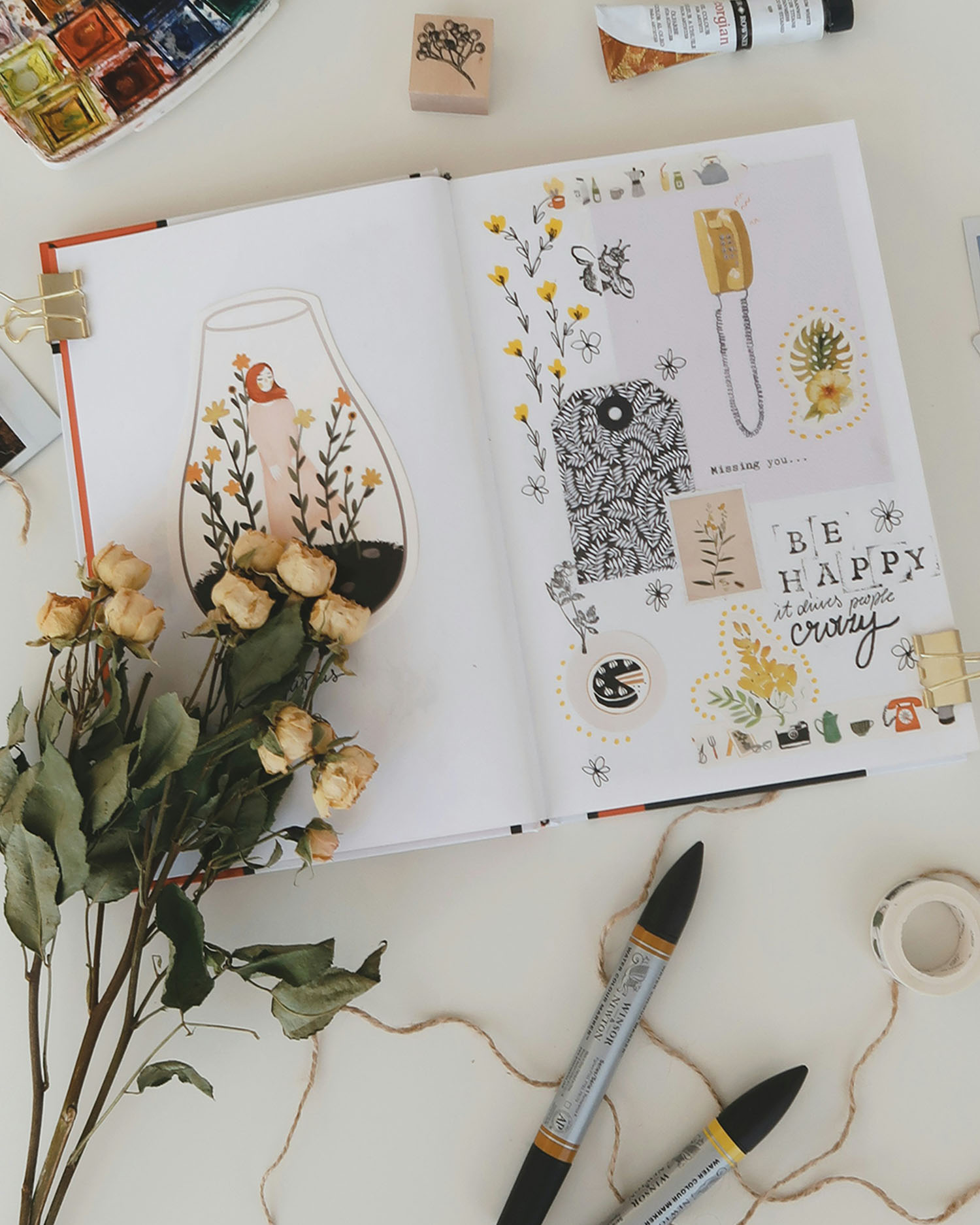 a display of flowers and craft pieces over a scrap book