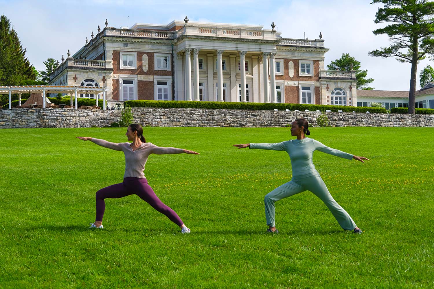 two women working out in front of the Lenox Mansion
