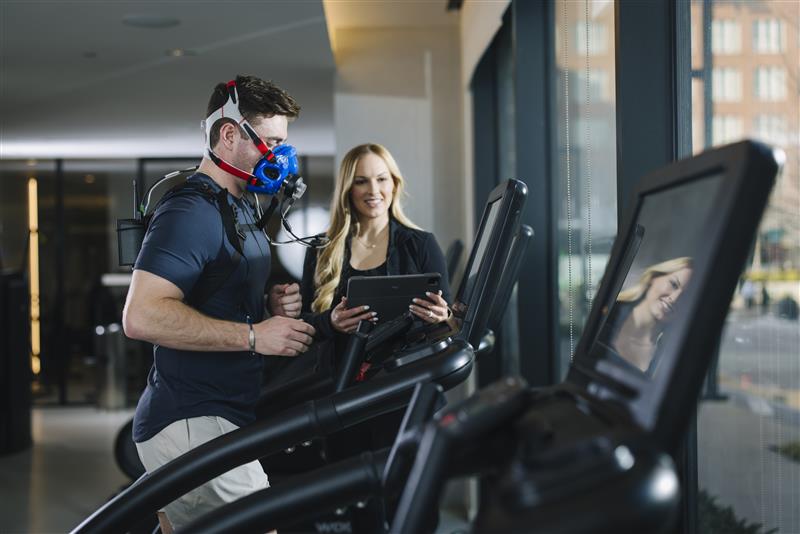 A man on a treadmill with a performance scientist