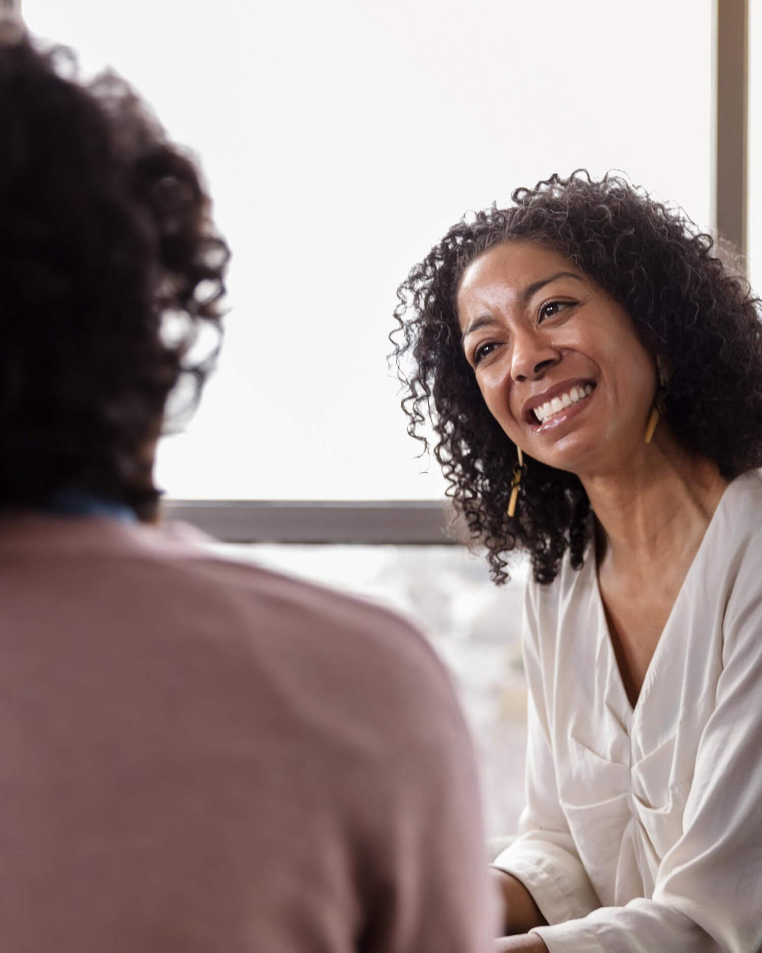 A woman with a therapist smiling