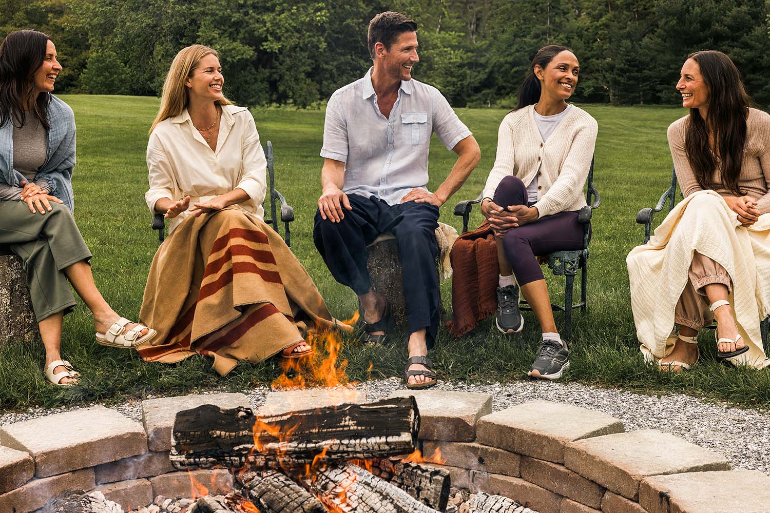a group of Adults around a campfire