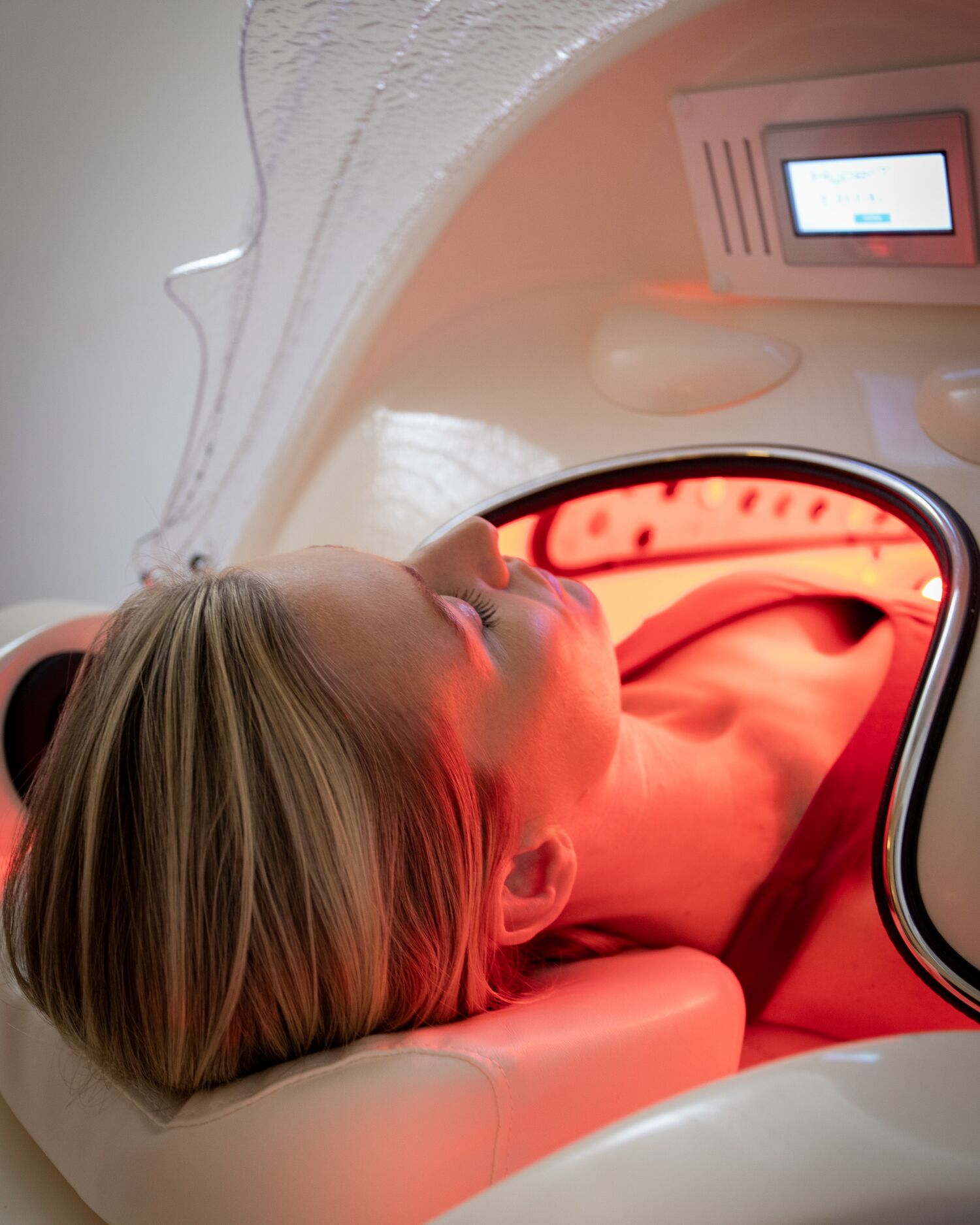 A woman in a state of the art infrared sauna pod