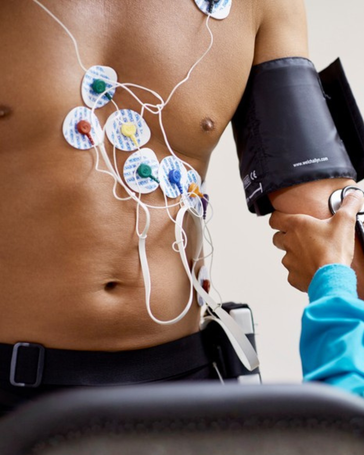 A man getting a 12 lead heart assessment with a doctor