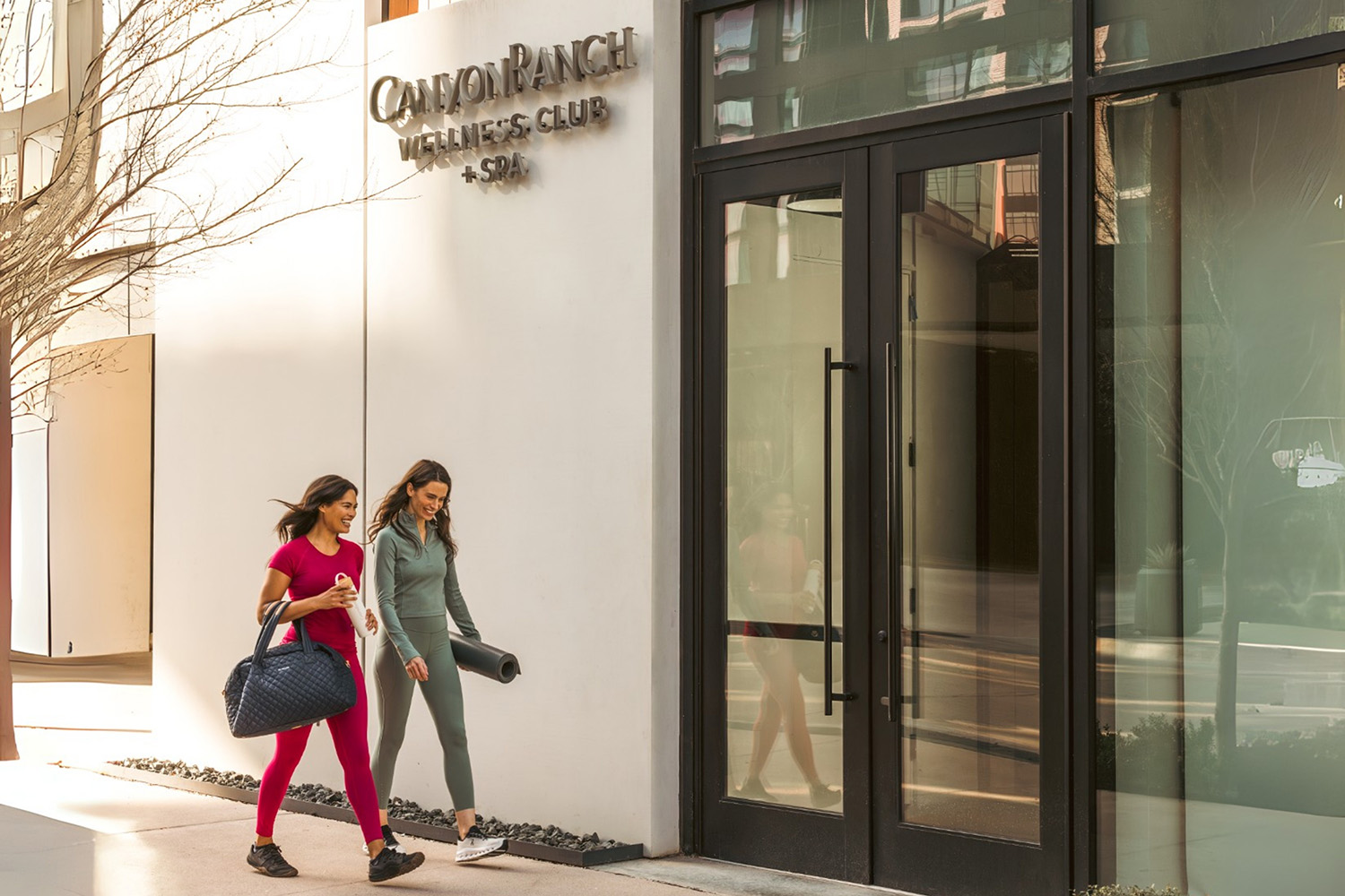 Women walking into Canyon Ranch Fort Worth Club