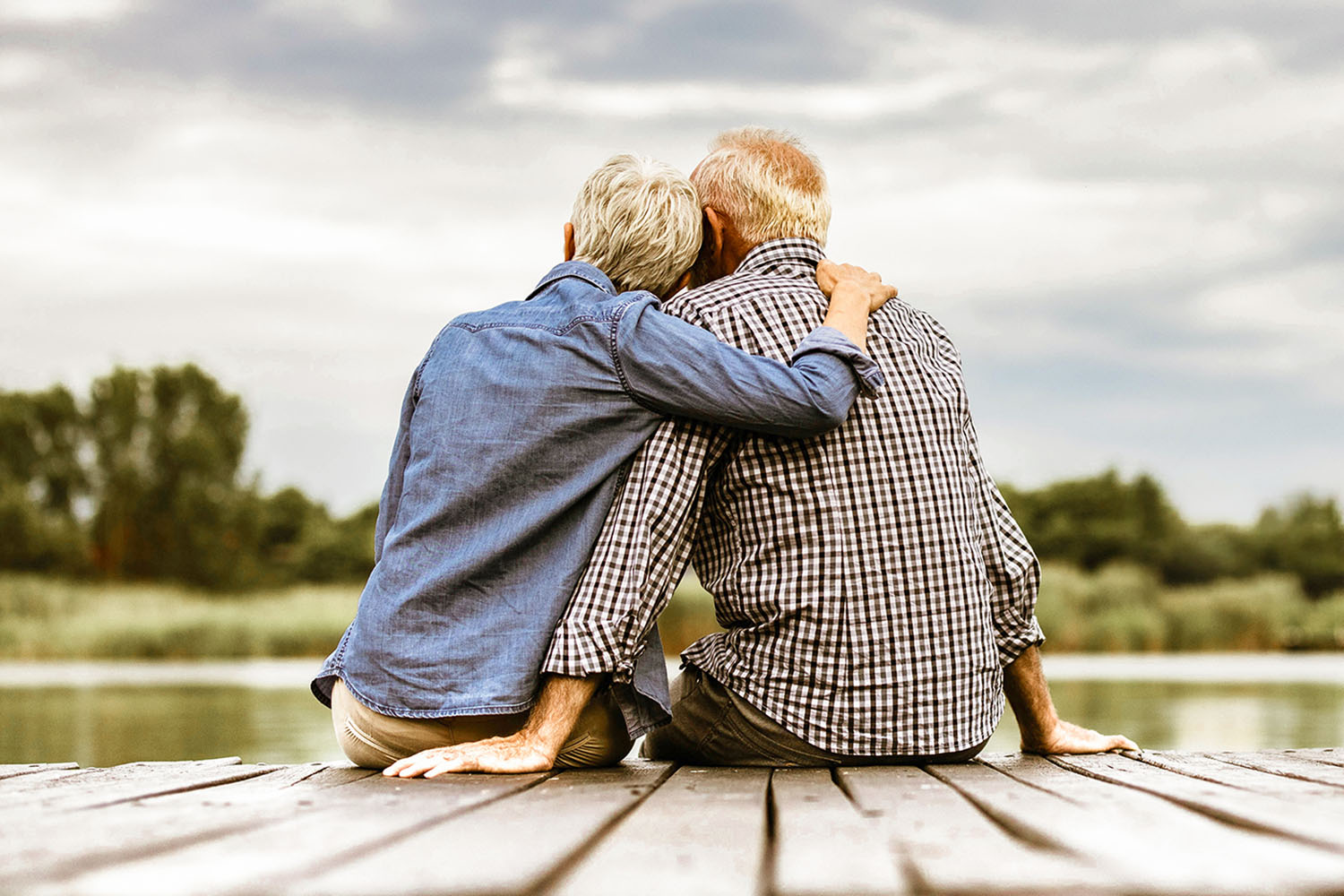a couple hugging watching a sunset